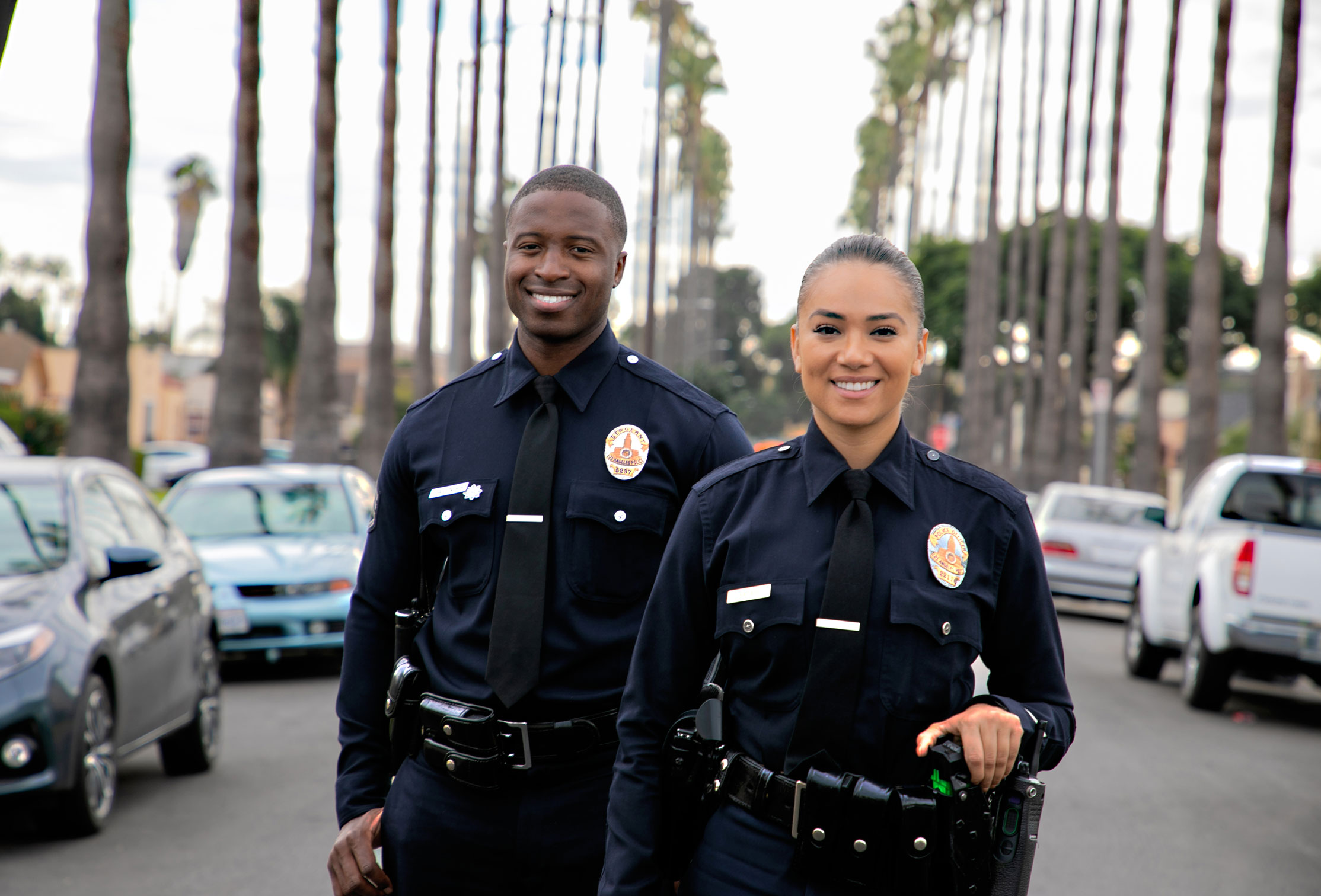 Two Police Officers smiling and looking at the camera. 