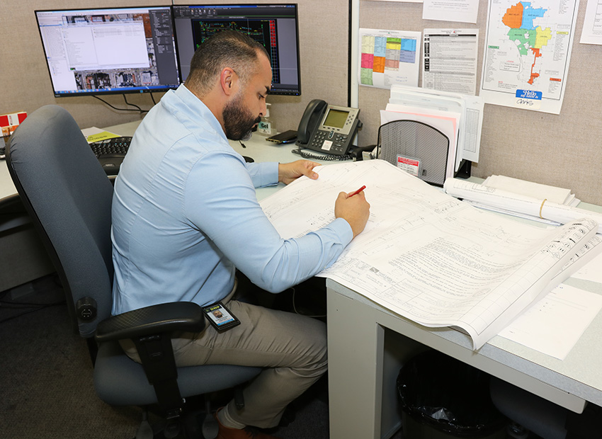 A civil engineering technician working at his desk. 